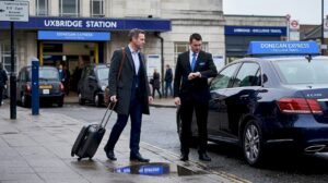 Business traveler approaching executive car at Uxbridge station